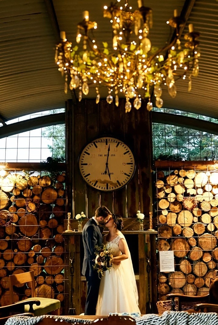 Wedding couple embrace in a country cabin.